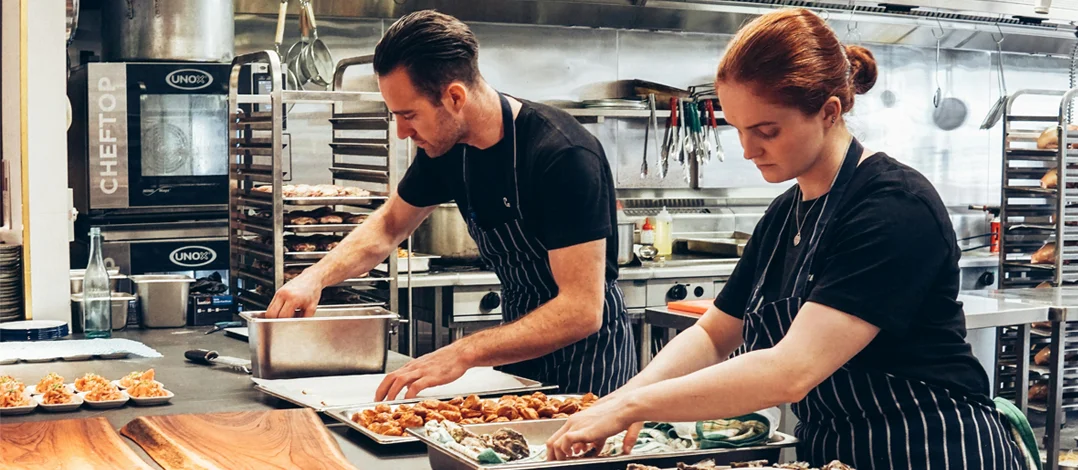 Caterers preparing food in the kitchen